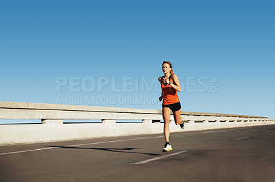 Buy stock photo Young female athlete sprinting on a highway