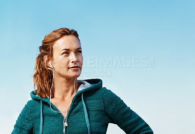 Buy stock photo Young athlete standing and looking away from the camera while wearing a hoodie