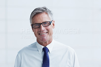Buy stock photo Head and shoulders shot of a confident senior businessman standing against a white background