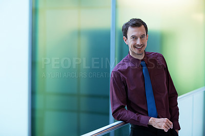 Buy stock photo Portrait of a smiling young businessman in an office setting