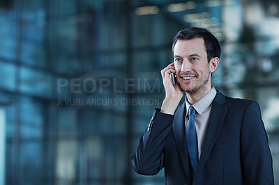 Buy stock photo Shot of a confident young businessman talking on his mobile phone
