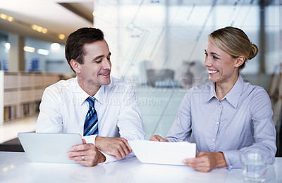Buy stock photo Shot of a businessman and businesswoman working together in an office