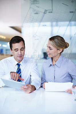 Buy stock photo Shot of a businessman and businesswoman working together in an office
