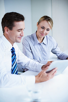 Buy stock photo Shot of two businesspeople working together in an office