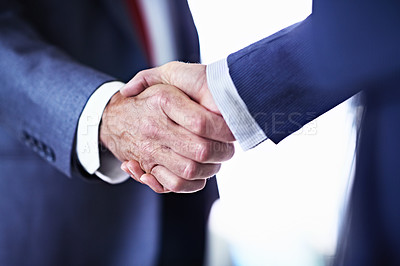 Buy stock photo Cropped closeup shot of two unrecognizable businessmen shaking hands