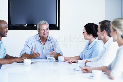 Buy stock photo Shot of a diverse group of businesspeople having a brainstorming session in an office
