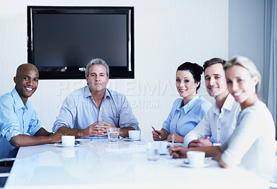 Buy stock photo Portrait of a diverse group of businesspeople having a meeting in a boardroom