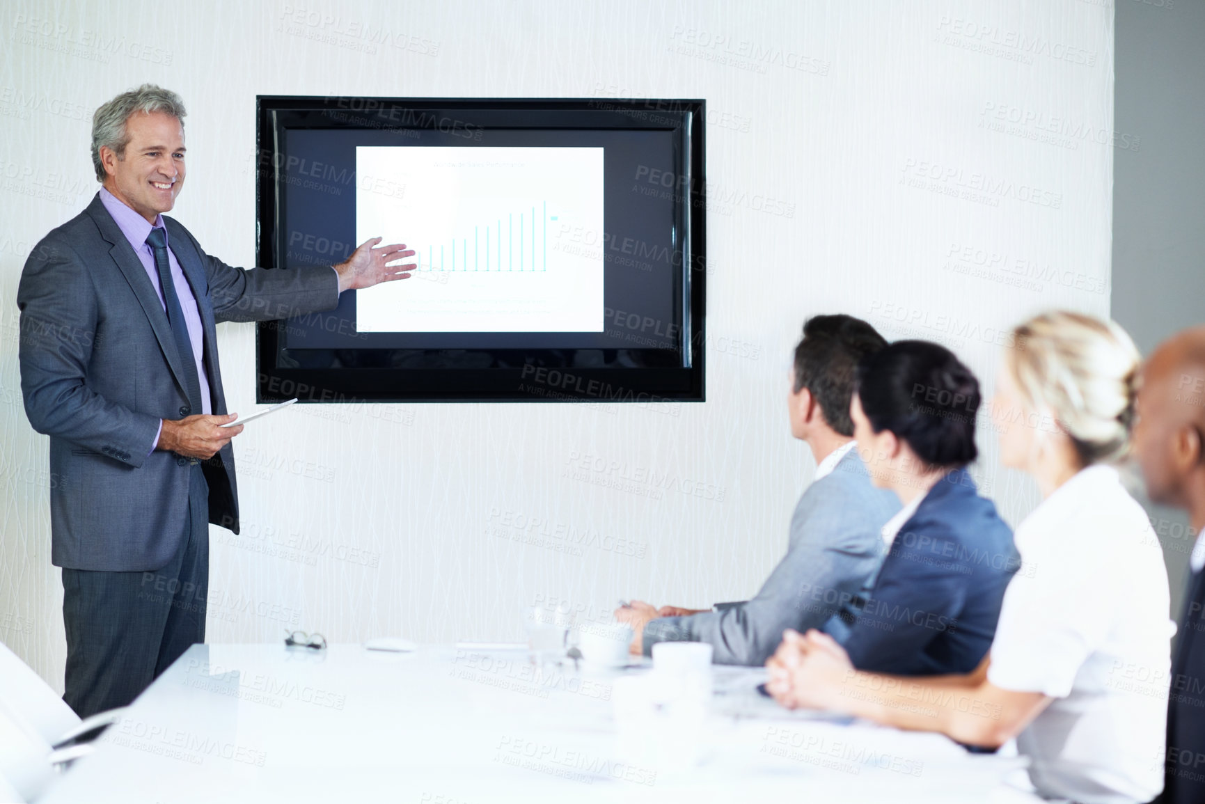 Buy stock photo Man, screen and tablet in presentation with pointing, graphs or revenue info at finance agency. Happy speaker, business people and monitor with chart for global sales performance, feedback and tech