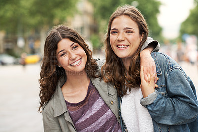 Buy stock photo Two young teen friends standing together happily while outdoors