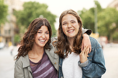 Buy stock photo Two young teen friends standing together happily while outdoors