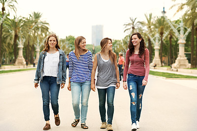 Buy stock photo A group of teen friends walking together while outdoors 