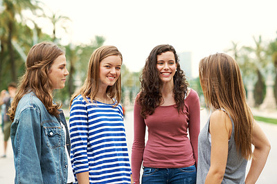 Buy stock photo Group of teen friends standing together and smiling while outdoors