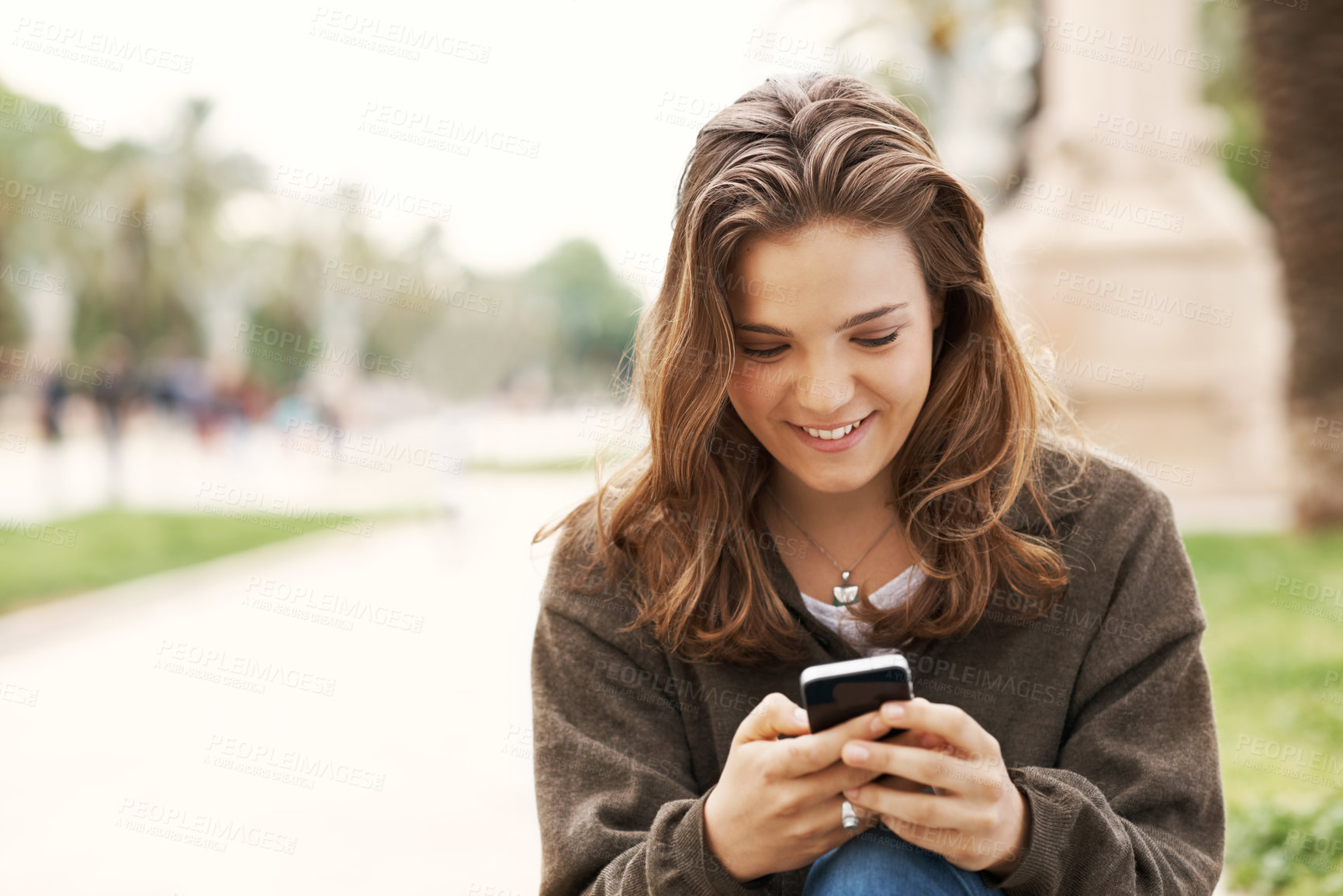 Buy stock photo Phone, student and reading with woman in park for college application, social media or smile. University portal, online academy review and communication with person outdoor for campus newsletter