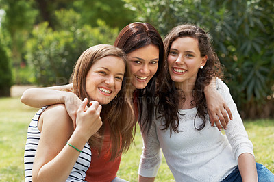 Buy stock photo Group of happy teen friends relaxing together outdoors on the grass