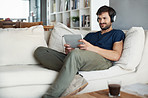 Chilling on the sofa with his tablet in hand