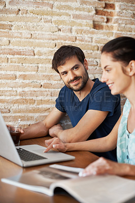 Buy stock photo A young couple sharing a laptop at home