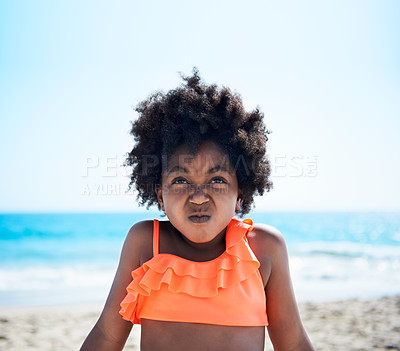 Buy stock photo A little African-American girl in an orange swimsuit pulling a face