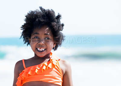 Buy stock photo A little African-American girl in an orange swimsuit on the beach smiling at the camera
