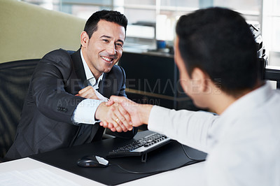 Buy stock photo Two businessmen shaking hands during a meeting