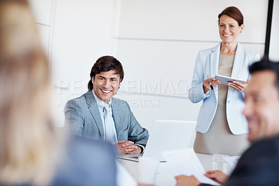 Buy stock photo A female executive giving staff training in a board room with a defocused foreground