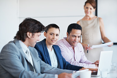 Buy stock photo Portrait of a young female businesswoman sitting amongst her colleagues during a seminar