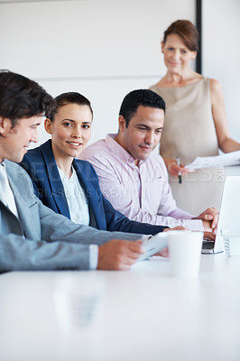 Buy stock photo Portrait of a young businesswoman sitting in a board room during staff training with a female manager