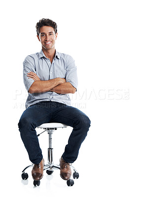 Buy stock photo Handsome young man smiling while sitting on a chair - isolated on white