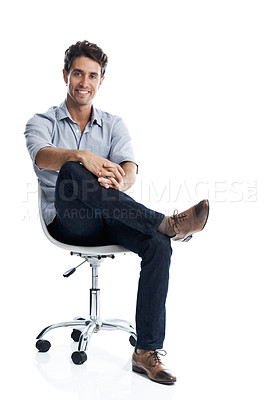 Buy stock photo Handsome young man smiling while sitting on a chair - isolated on white