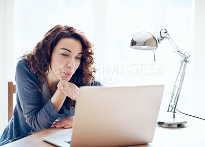 Buy stock photo A beautiful young woman blowing a kiss while video chatting on her laptop