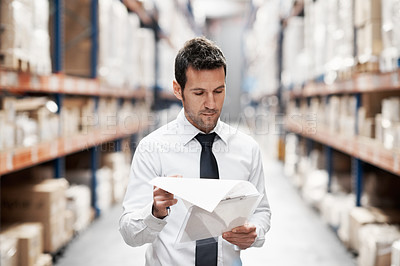 Buy stock photo Focused warehouse worker doing a stocktake while in a warehouse