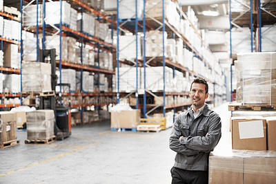 Buy stock photo Portrait of a handsome warehouse worker smiling with his arms folded