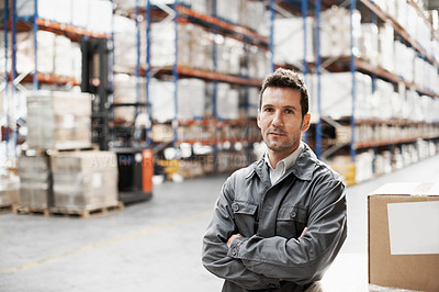 Buy stock photo Portrait of a handsome warehouse worker with his arms folded