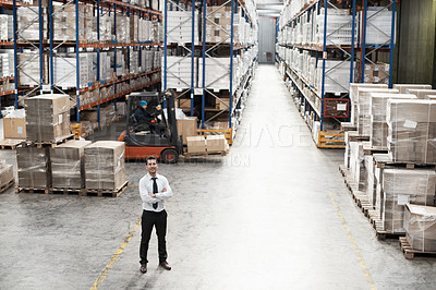 Buy stock photo Portrait of a handsome warehouse worker with his arms folded