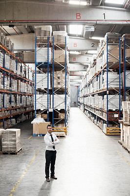Buy stock photo Portrait of a handsome warehouse worker with his arms folded