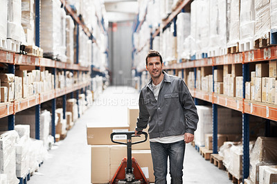 Buy stock photo Portrait of a young man using a pallet truck to pack boxes in a warehouse