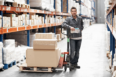 Buy stock photo Portrait of a young man using a pallet truck to move stock in a warehouse