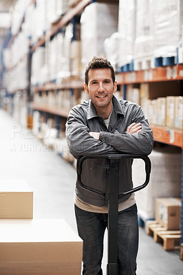 Buy stock photo Portrait of a young man standing in a storehouse