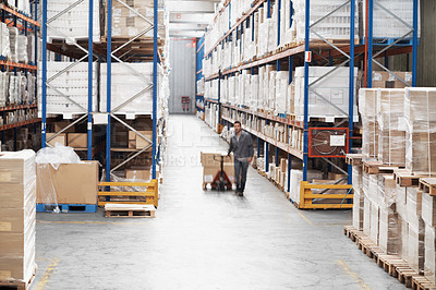 Buy stock photo A young man moving inventory in a warehouse using a pallet truck