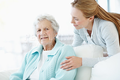 Buy stock photo Happy, comfort and old woman at house with daughter, love and connection for bonding together. Portrait, person and relax in lounge with senior mother, compassion and elderly care for weekend break