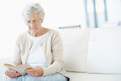 Buy stock photo Relax, book or old woman on sofa with reading, fantasy novel or insight in literature hobby. Chill, glasses or senior person in house with fairytale, peaceful moment or fiction story in retirement.