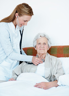 Buy stock photo Doctor, stethoscope and old woman in bedroom for heart health, assessment and breathing evaluation. Portrait, senior person and healthcare worker listen with medical tools, cardiology or house visit.