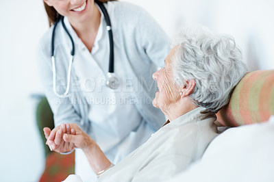 Buy stock photo Nurse, holding hands and elderly woman in bed for homecare, healthcare and support with smile. Help, happy and medical service with caregiver and senior patient with assisted living at nursing home