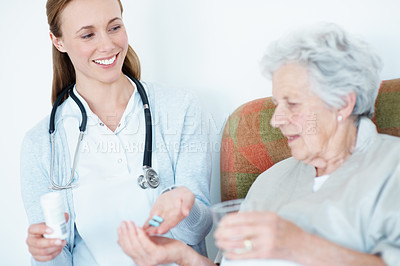 Buy stock photo Nurse, help and senior woman with pills for healing, recovery or wellness prescription at home. Patient, medical caregiver and giving medicine with water for elderly care, healthcare and smile