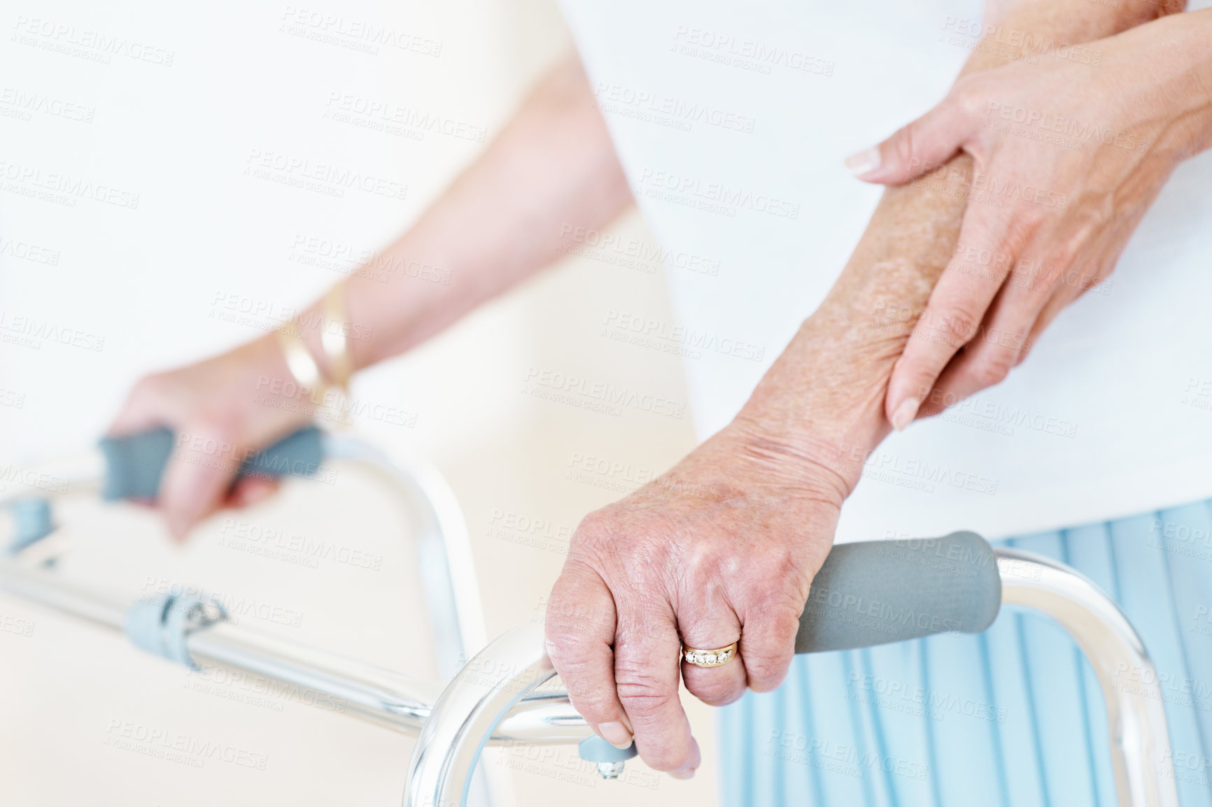 Buy stock photo Hands, walker and caregiver with elderly person for help, balance or care in assisted living. Nurse, walking frame or woman with disability in retirement, rehabilitation or service for mobility aid