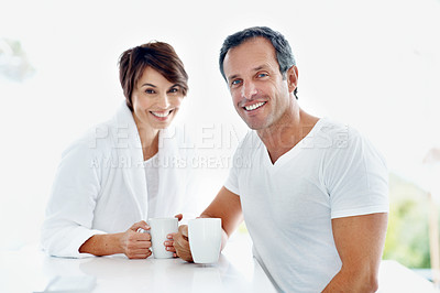 Buy stock photo Couple, portrait and smile in home with coffee for break, relax or morning start with drink. People, marriage and connection with beverage, happy and bonding for relationship and routine in house