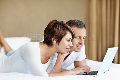Buy stock photo Happy, laptop and couple relax in bedroom with love, care and bonding with comfort and web in home. Man, woman and technology on bed with internet connection, streaming online and movie subscription