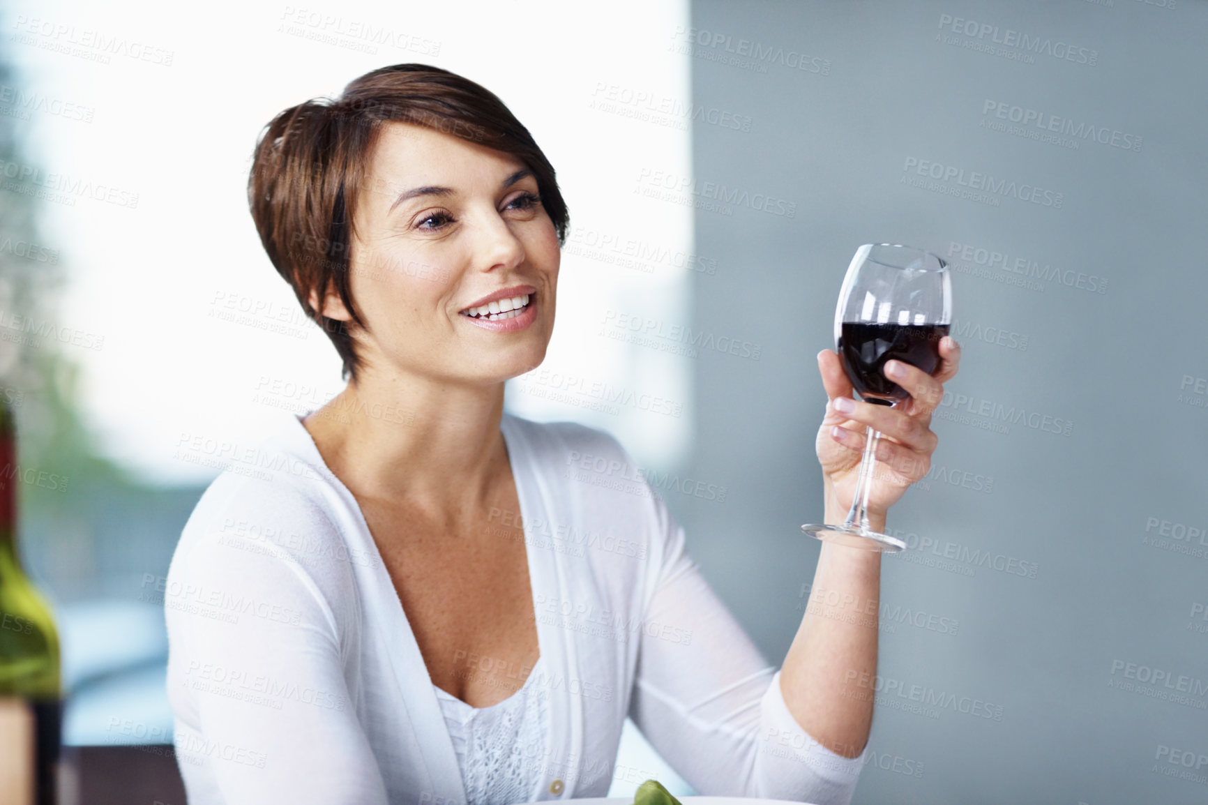 Buy stock photo Woman, thinking and relax with wine in house, decision and positive attitude with liquor on weekend. Happy, memory and person with alcohol, reflection and contemplating with beverage in apartment