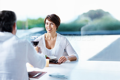 Buy stock photo Dinner, love and couple cheers with red wine at date, connection and anniversary celebration. Happy woman, man and toast with alcohol glass for romance, relationship goal and space with food at home