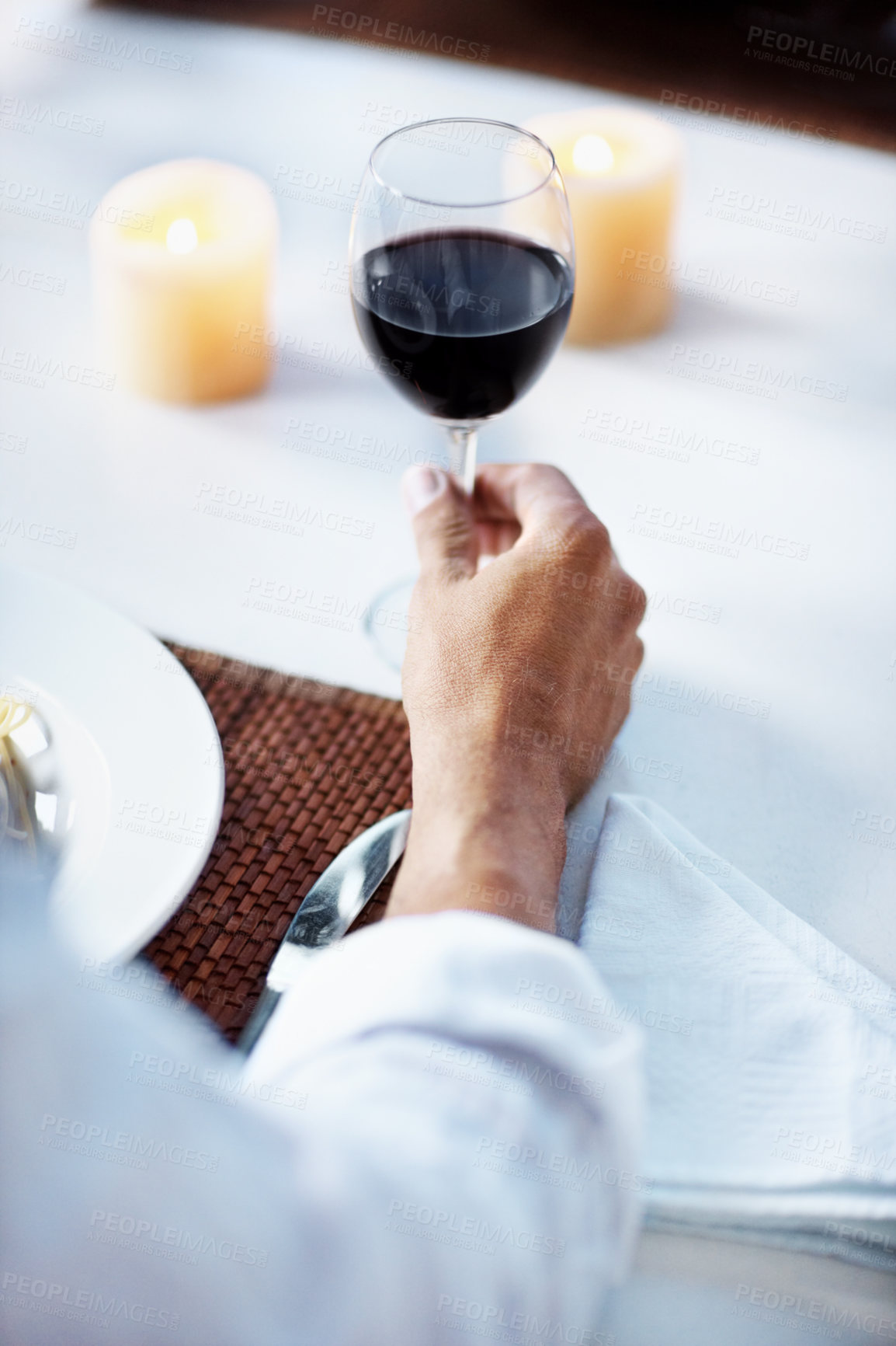 Buy stock photo Hand, red wine and man at dinner in restaurant for tasting, fine dining or gourmet experience. Cuisine, sommelier and male person with glass of alcoholic drink with luxury supper at winery diner.