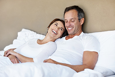 Buy stock photo Love, care and laughing with couple in bedroom in home for wake up, connection and romantic partner. Bonding, support and morning with man and woman in bed in apartment for funny joke and comedy